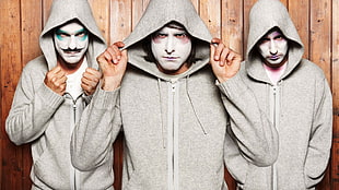 three men wearing gray zip-up hoodies