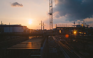 white and brown buildings, sunlight, railway, sunset, cityscape