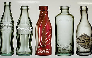 five empty bottle of Coca-Cola