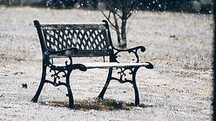black metal framed glass top table, bench, snow