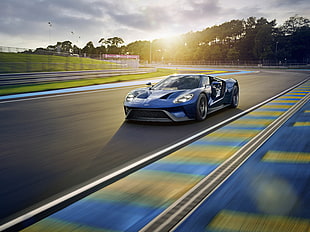 blue sports car on race track during day time HD wallpaper