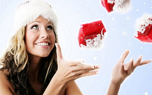 woman with santa hat throwing gift photo