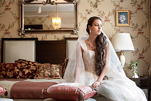 woman in white wedding dress on bed