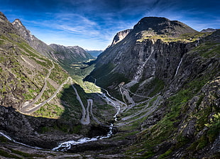 photography of green and grey high mountains under blue sky at daytime, rauma, norway
