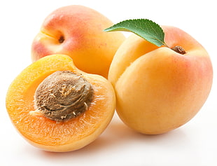 close photo of three pomegranate fruits