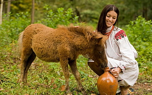 woman feeding the pony