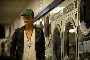 woman in black jacket standing near clothes washer