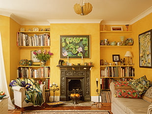 waterlily painting with brass-colored frame hanging in the yellow colored wall