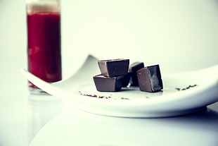 brown chocolates in white ceramic plate