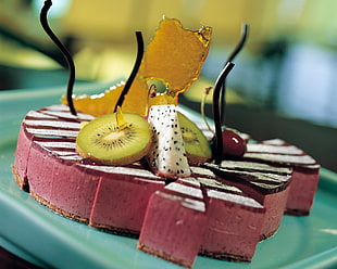 pink and white sliced cake with slice kiwi fruit