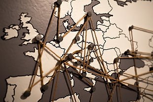 world map with brown strings connection closeup photography