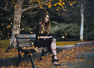 woman in black dress sitting