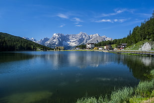 landscape photography of mountain near body of water surrounded by pine trees, lake misurina