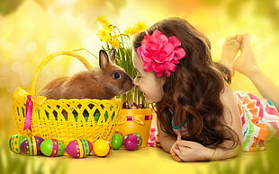 brown rabbit and girl nose to nose photo