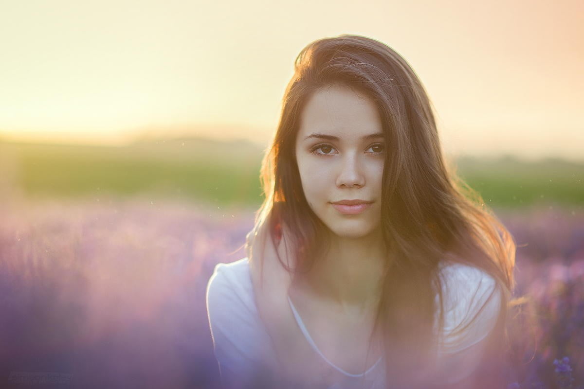 selective focus shot of woman wearing white top on purple flower field