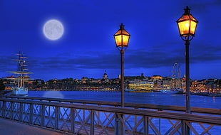two black steel post lamps in gray bridge, stockholm