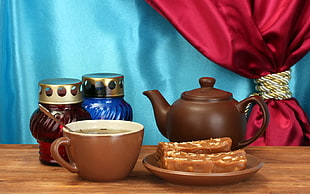brown teapot on top of brown wooden table