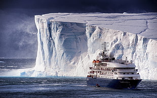 white and black concrete building, ship, iceberg, sea