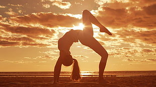silhouette photography of woman doing yoga during sunset