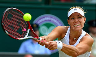 Tennis Player wearing white tank top playing