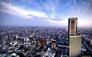 aerial view of city buildings under cloudy sky, city