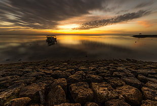 reflection photography of yellow and gray Skies During sunset