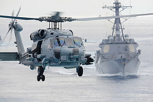 gray helicopter near ship