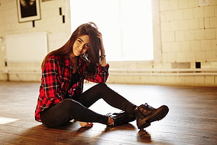 woman in red, black, and grey plaid sports shirt and black leggings