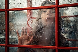 women blower on glass window with heart decor