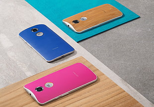 three assorted color Motorola Moto android smartphones