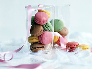macaroons in clear glass canister beside white feathers