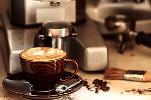 cup of cappuccino beside coffee grinder with brush near portafilter HD wallpaper