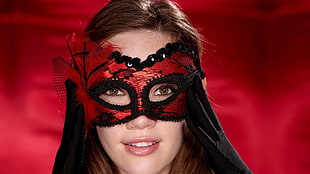 woman wearing red and black masquerade