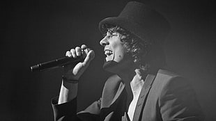 grayscale photo of man singing