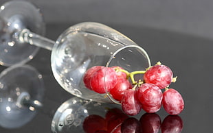 grape inside clear long-stemmed wine gass
