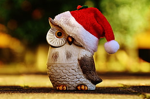 gray and black owl wearing Santa hat figurine