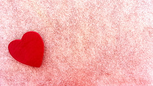 red heart on pink surface HD wallpaper