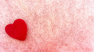 red heart on pink surface