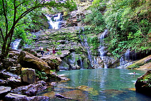 group of people swimming at clear blue waterfalls, cocal