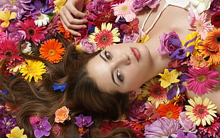 photography of a woman in bed of flowers