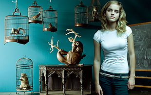woman in white crew-neck cap-sleeved shirt and black bottoms standing near animal cages inside the room HD wallpaper