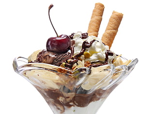 ice cream with cherry and wafer sticks