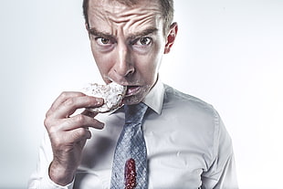 man wearing white dress shirt eating cookie HD wallpaper