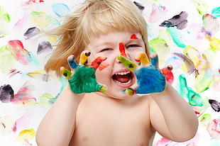 toddler in topless playing multicolored colors