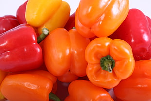 close up photography of red and orange bell peppers
