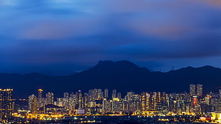 high-rise commercial buildings, cityscape, mountains