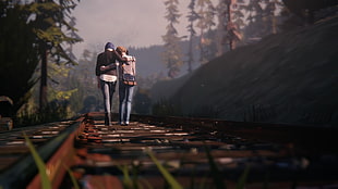 two person walking on railway surrounded by trees