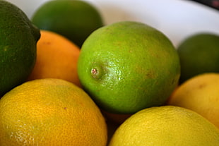 shallow focus photography green Lemon fruit