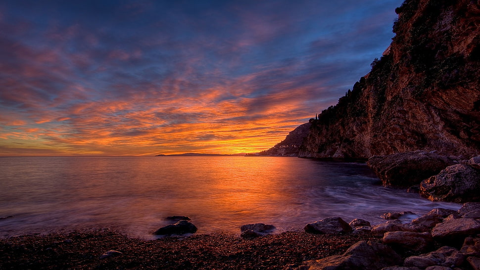 brown rock cliff, sunlight, coast, sky, clouds HD wallpaper