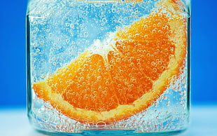sliced of orange in glass container